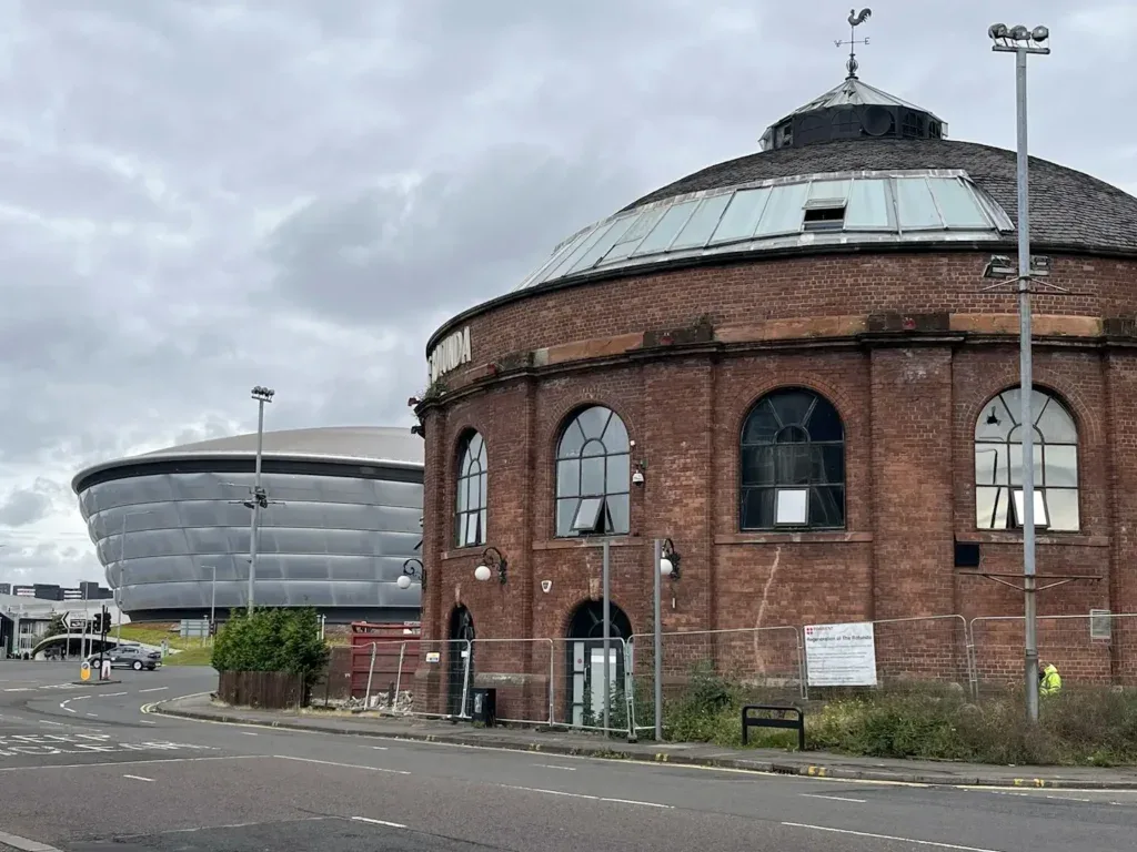 An old building with the Scottish Event Campus in the background.
