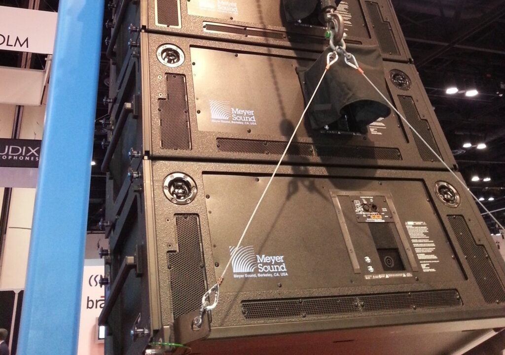 Sound equipment being hoisted into the air on a winch.