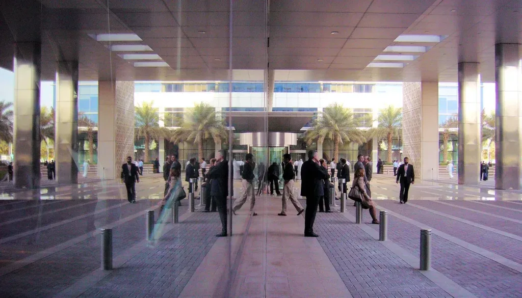 A group of people walking outside of a building.