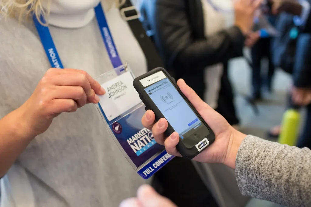 A person uses a lead scanner app to scan an attendee's pass.