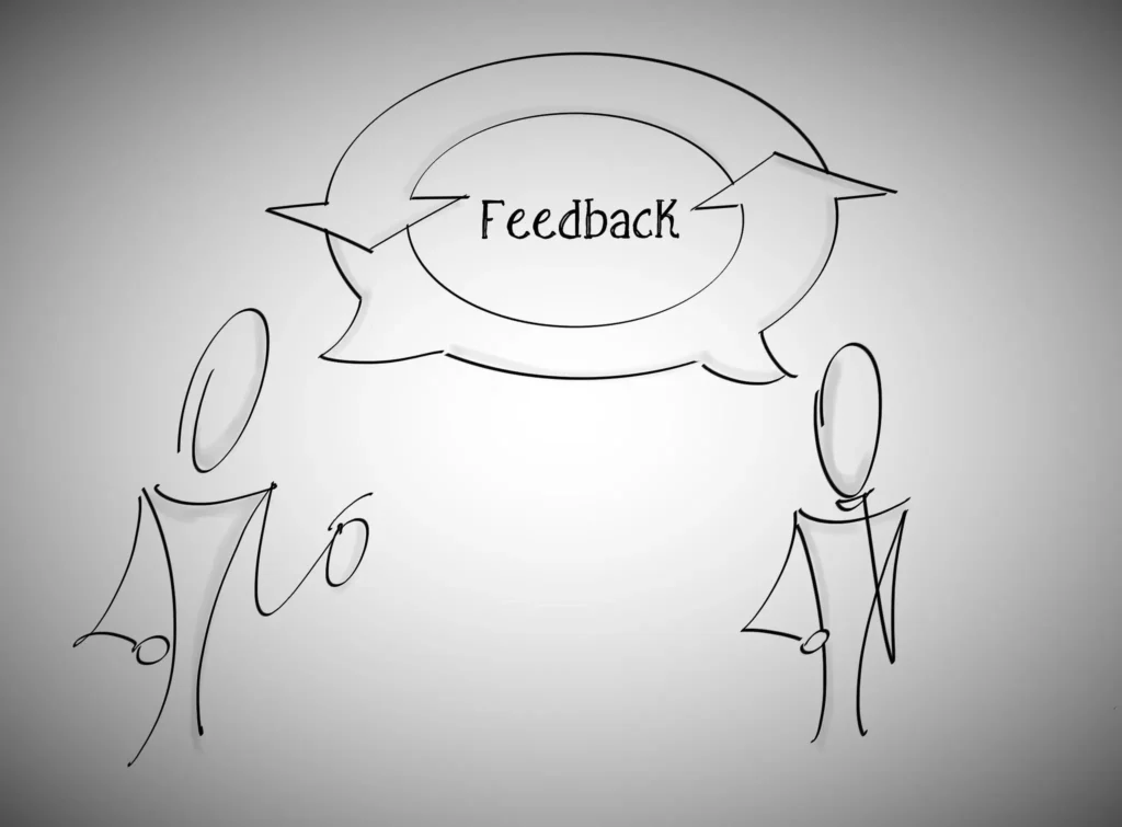 A cartoon with two people speaking to each other with the word "feedback" shown in the speech bubble. 