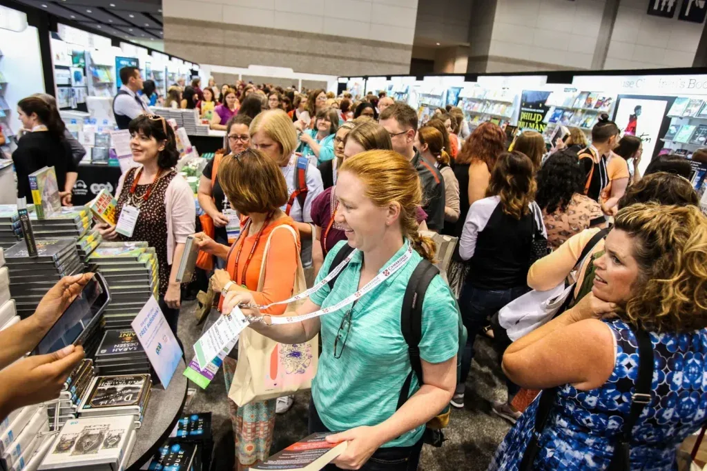 A book stand receives a crowd of visitors at an exhibition. 