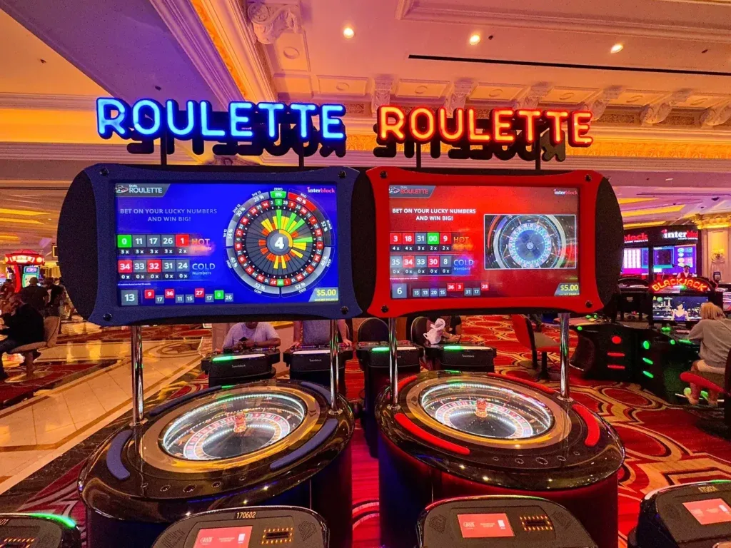 A blue roulette machine and a red roulette machine placed alongside one another.