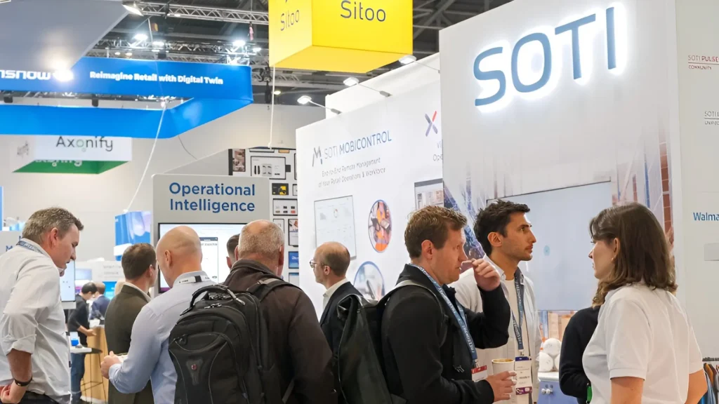 Guests gather around the SOTI trade show booth built by Booth Exhibits™ in London. 