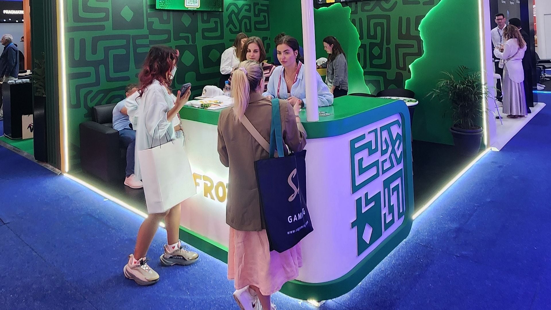 Portable trade show attendees speak with booth staff at the 2025 SiGMA Africa show...