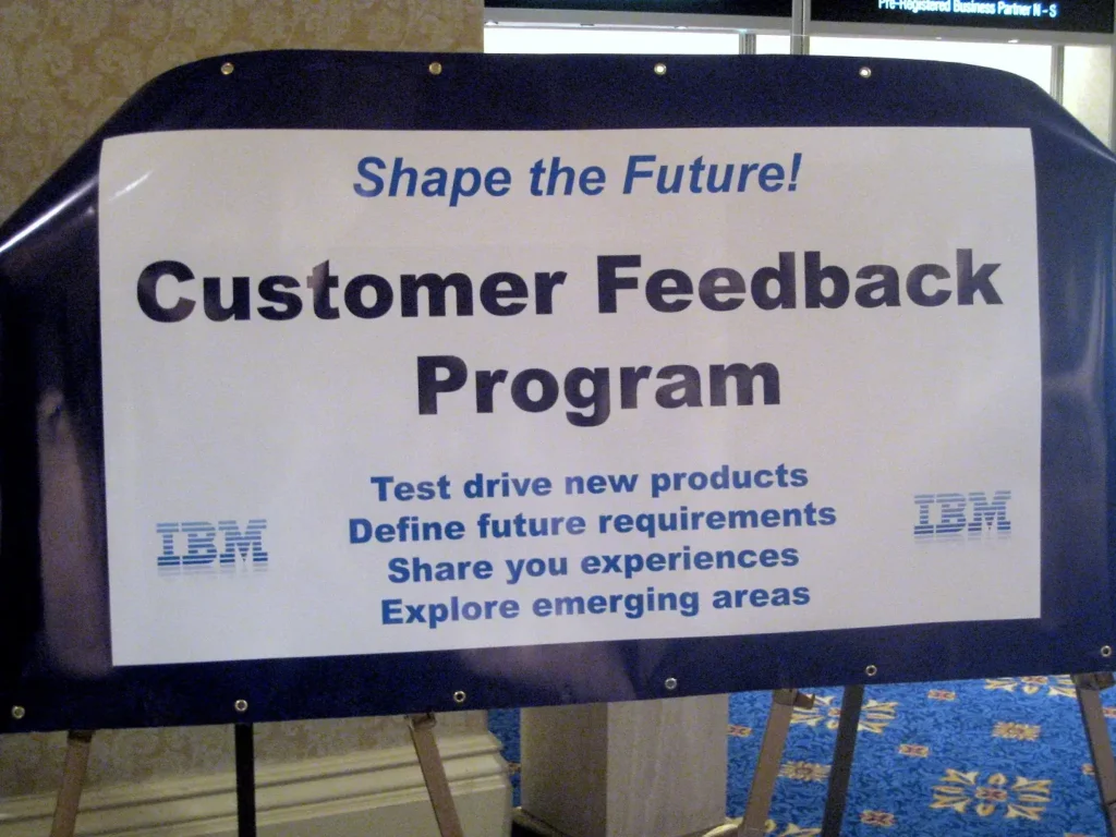 An IBM sign informing people of their customer feedback program.