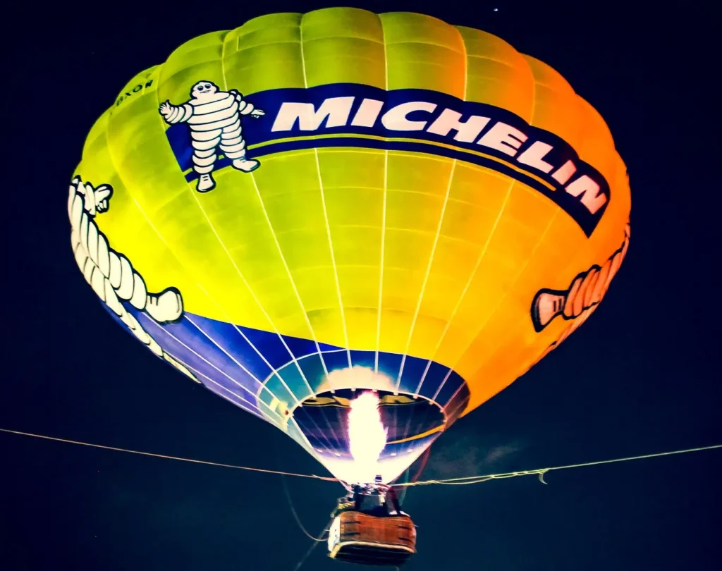 A large Michelin-branded hot air balloon in the sky.