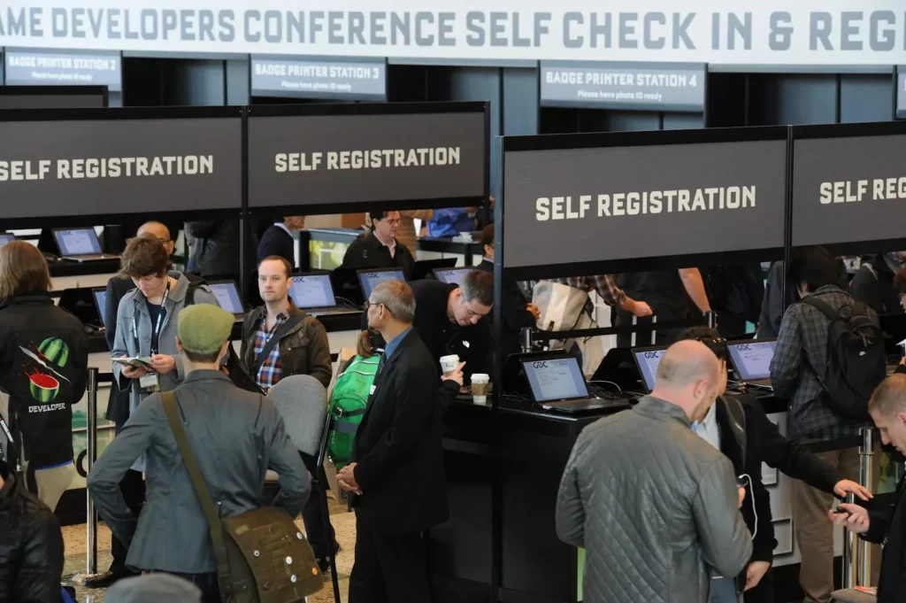 Multiple self-registration kiosks for attendees at a larger exhibition.