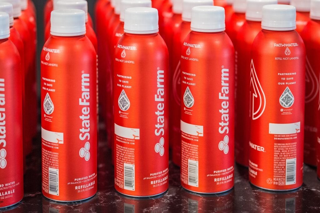 Red refillable water bottles made of metal.