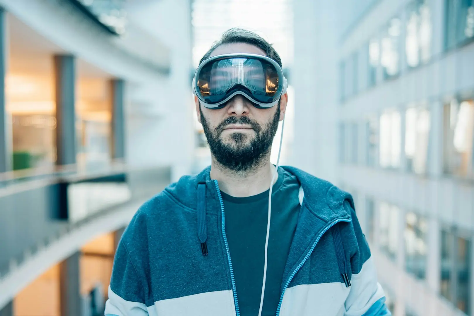 A man wearing VR goggles looking toward the camera.