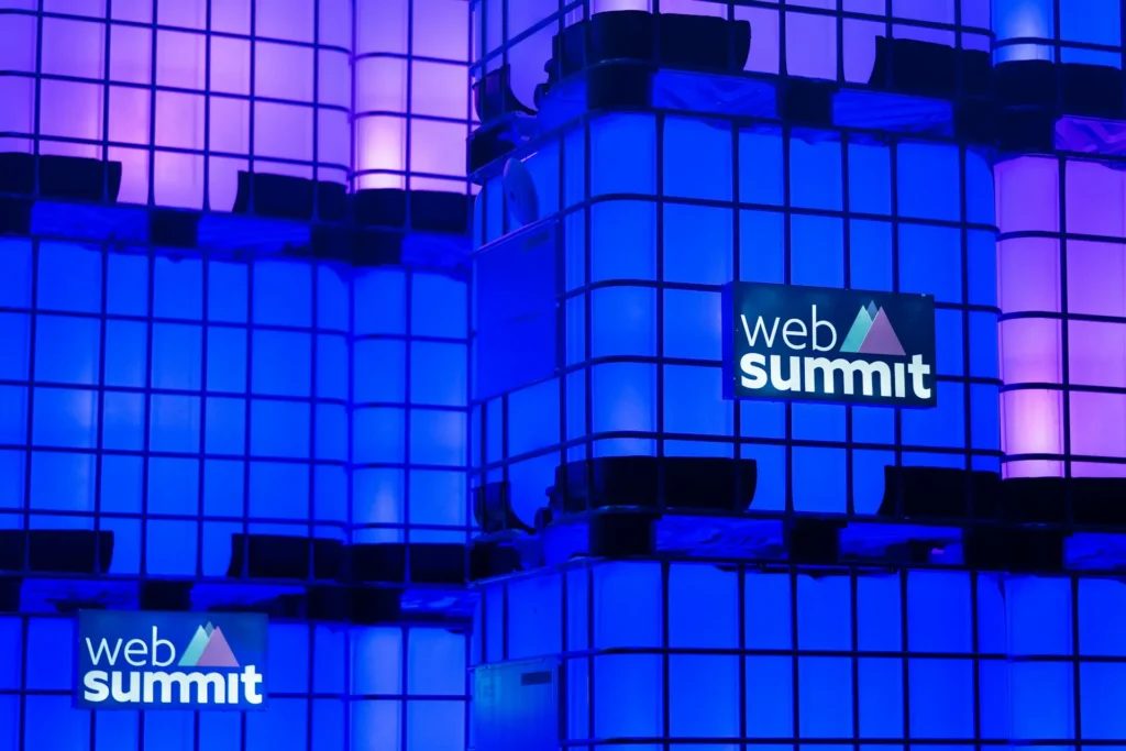 Blue and purple lighting with Web Summit signage. 