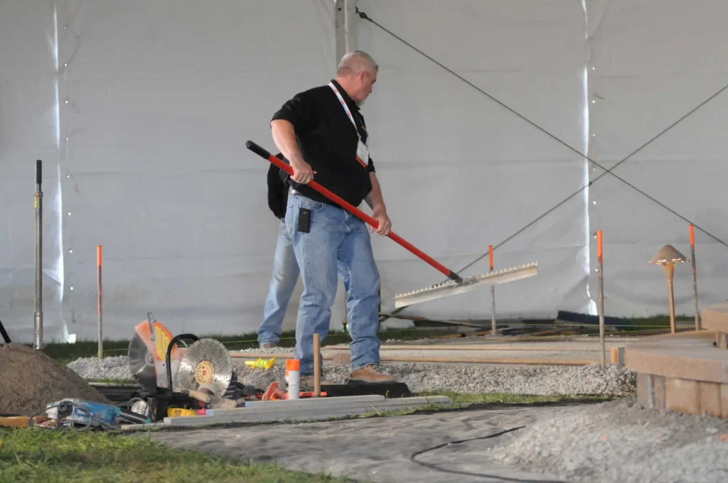 An attendee takes part in a hardscaping demo. 