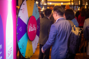 People near a colorful prize wheel.