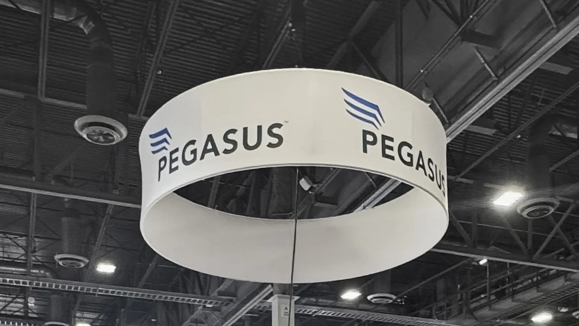 Hanging banner display for Pegasus Solar built by Booth Exhibits™