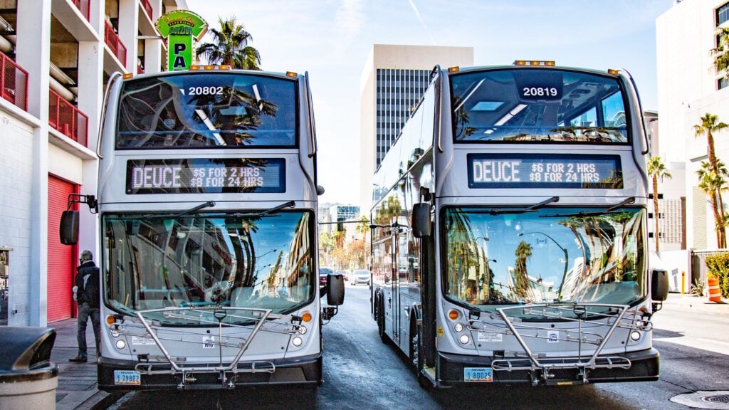 Two RTC Transit Deuce busses in a street. 