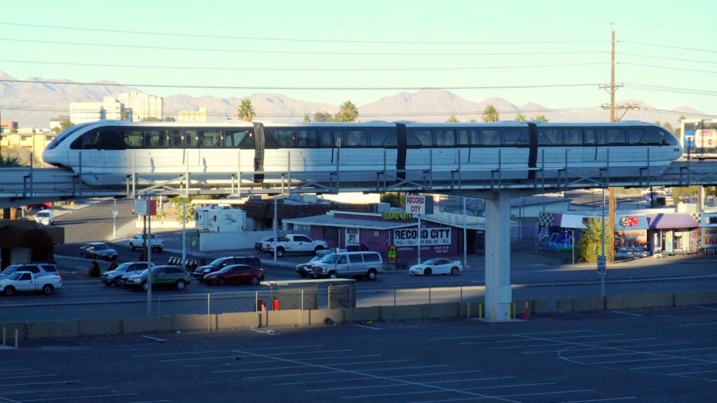 The Las Vegas Monorail seen passing by an empty parking lot. 
