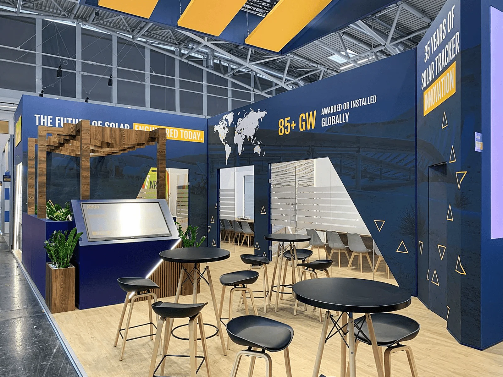 Array exhibition stand builders UK with wood pergola and bar seating area