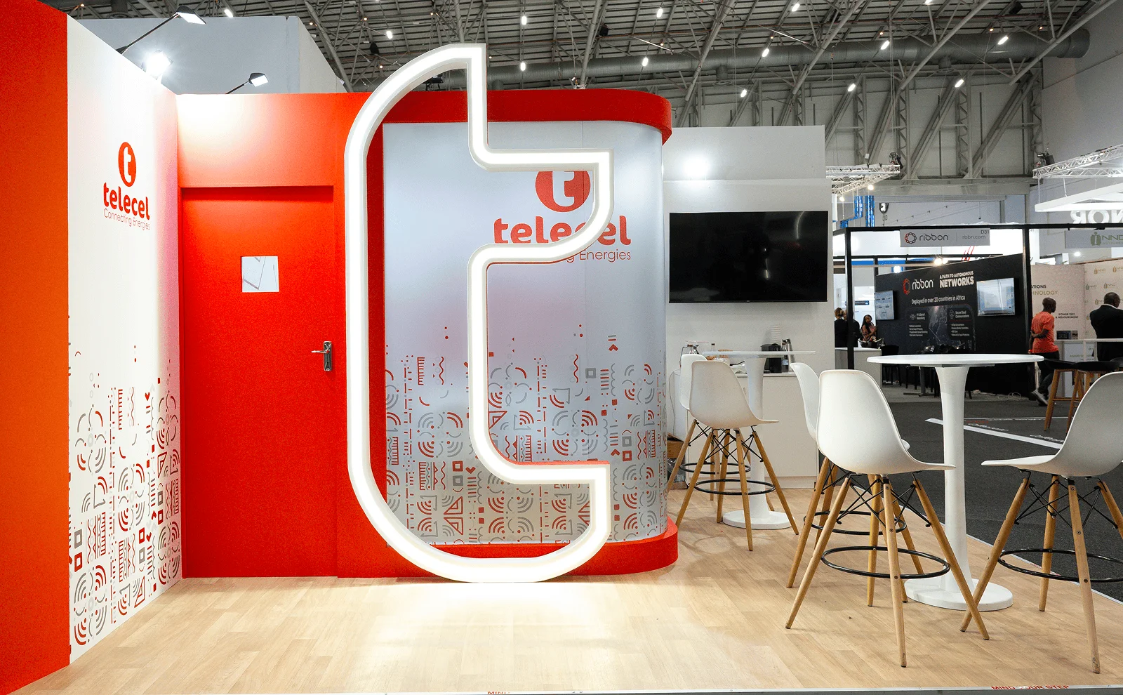 Telecel exhibition stand builders UK with red white and illuminated logo