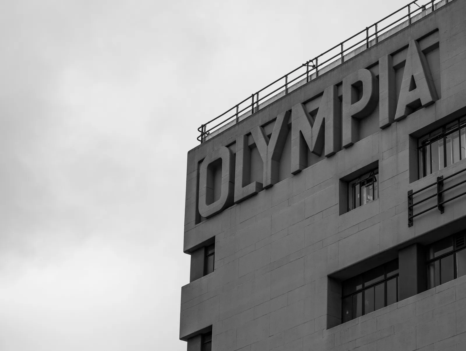Olympia London venue exterior showing the iconic OLYMPIA sign on the building facade