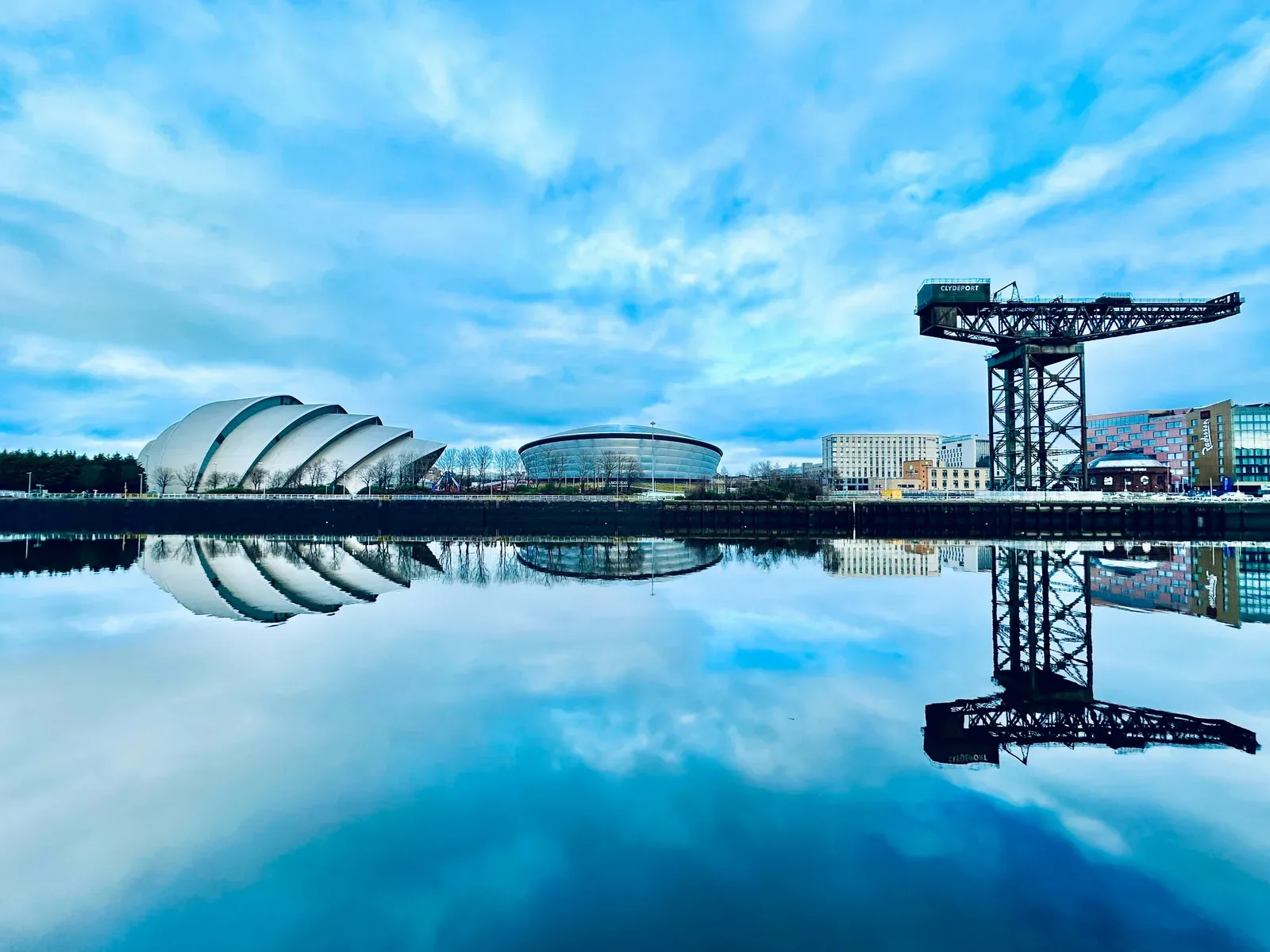 SEC Glasgow Scottish Event Campus buildings reflected in the River Clyde, with the Finnieston Crane