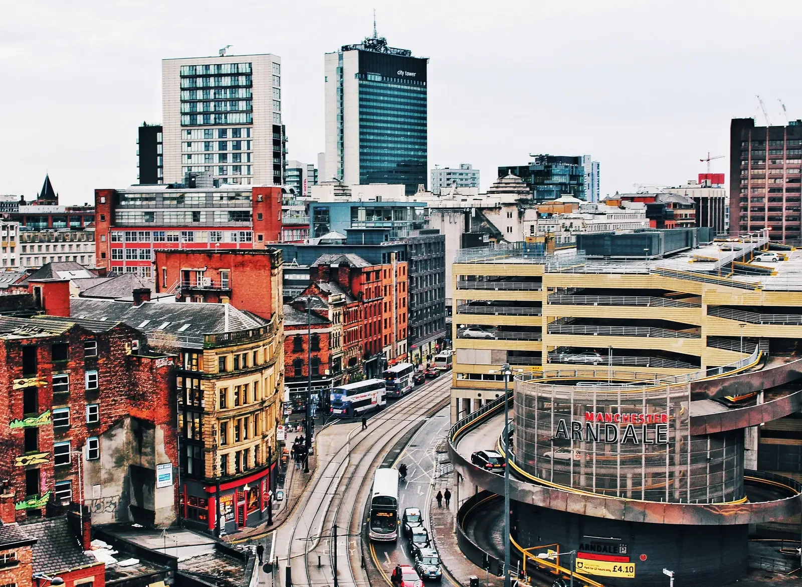 Manchester city centre skyline with the Arndale shopping centre, tram lines and Victorian red-brick architecture