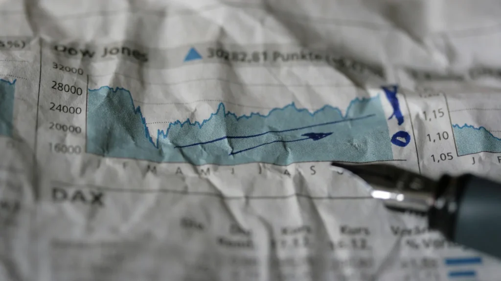 A crumpled financial chart with an annotated graph on it.