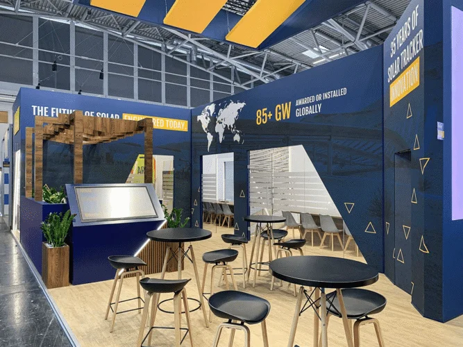 Array trade show booth with wood-slatted pergola and blue gold branding