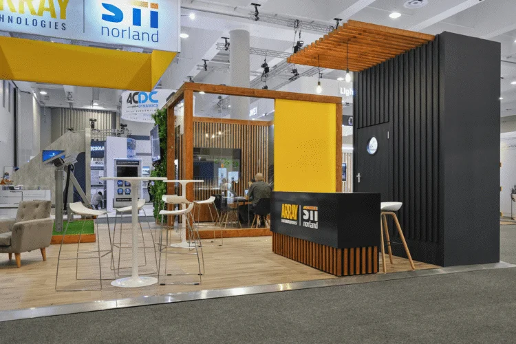 STI Norland Array trade show booth with dark theme and wood-slatted roof